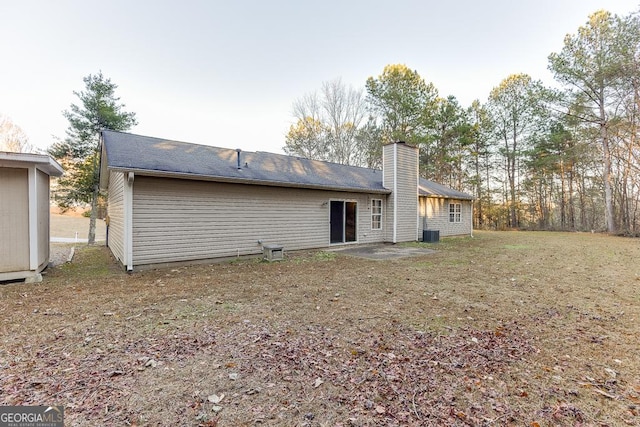 rear view of house featuring a patio area and central air condition unit