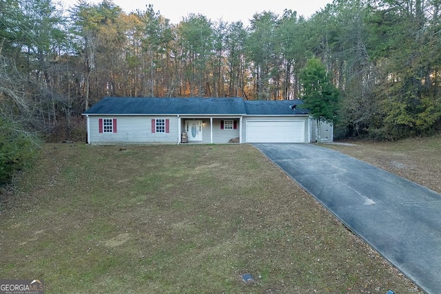 ranch-style home with a garage and a front lawn