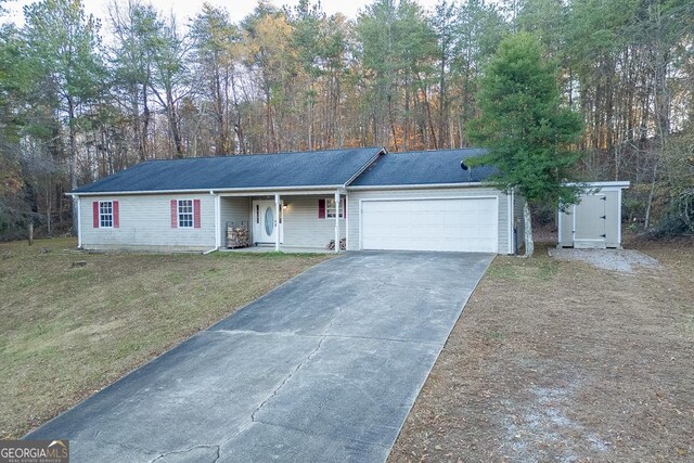 single story home with a front yard, a porch, and a garage