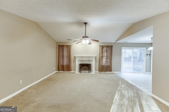 unfurnished living room featuring a textured ceiling, ceiling fan, light carpet, and vaulted ceiling