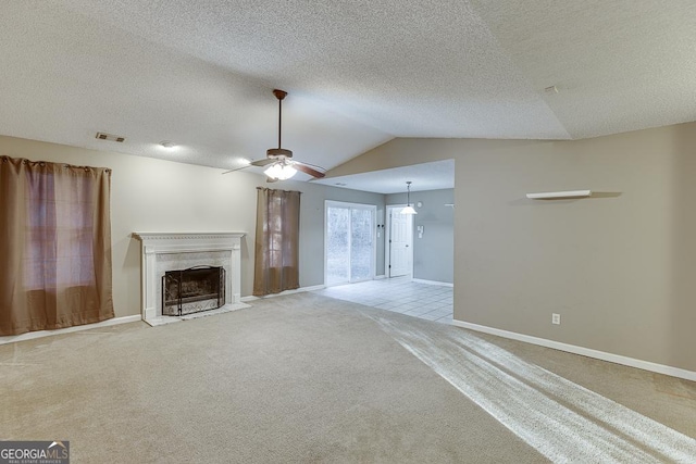 unfurnished living room with light carpet, a textured ceiling, ceiling fan, and lofted ceiling