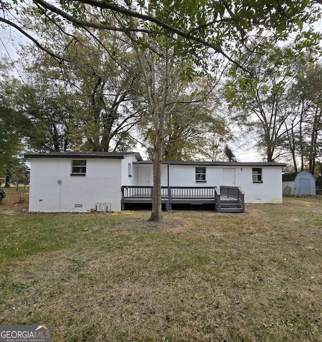 view of front of house with a front yard and a deck