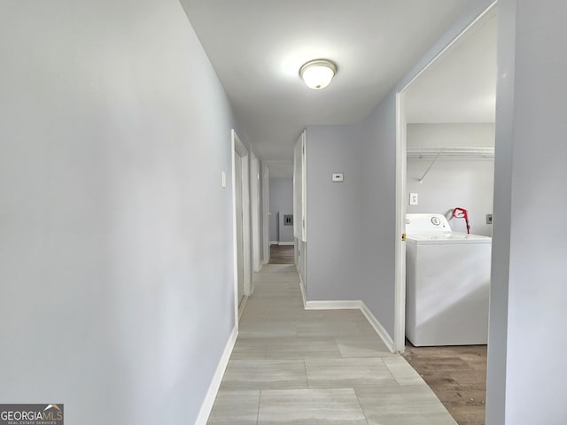 corridor featuring light hardwood / wood-style floors and washer / dryer