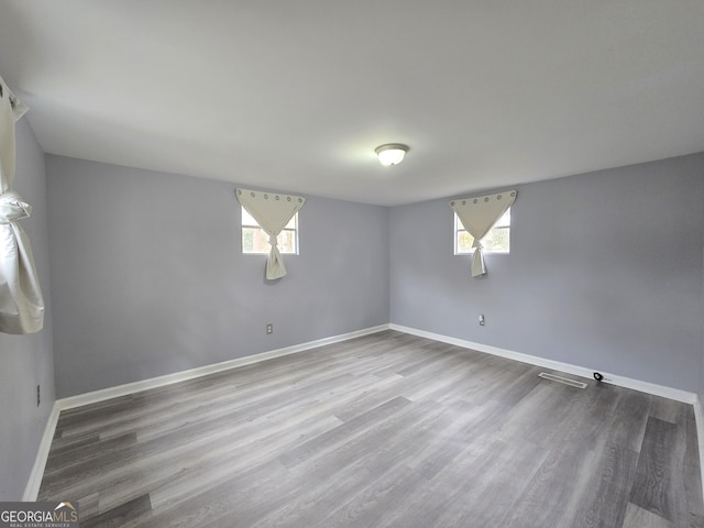 basement with hardwood / wood-style flooring and plenty of natural light