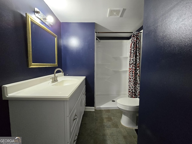 bathroom featuring vanity, toilet, and curtained shower