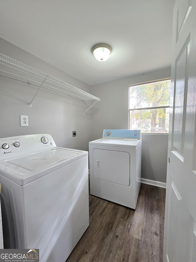 laundry room featuring dark hardwood / wood-style floors and washer and clothes dryer