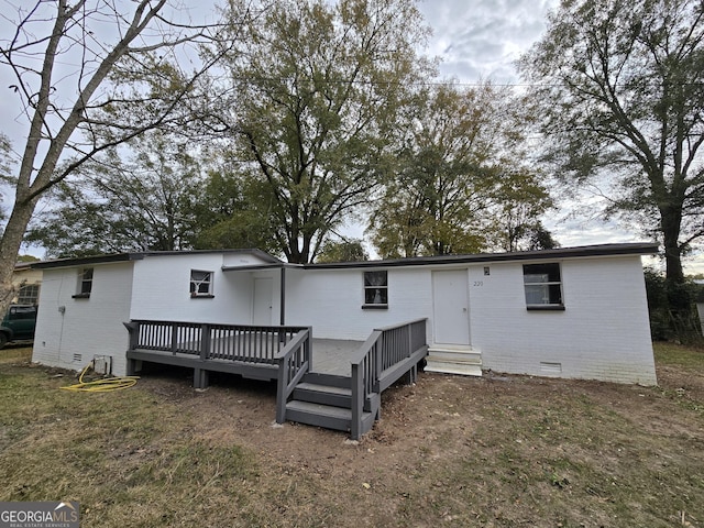 rear view of property featuring a deck