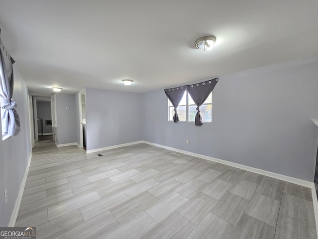 empty room with light hardwood / wood-style flooring