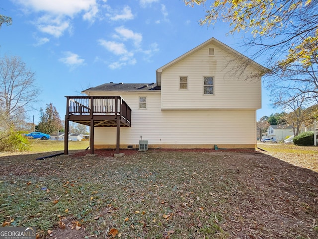 rear view of property with central air condition unit and a wooden deck