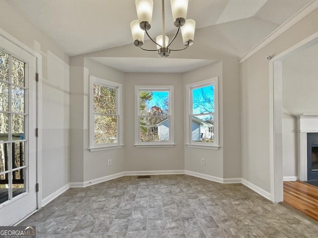 unfurnished dining area featuring vaulted ceiling and an inviting chandelier