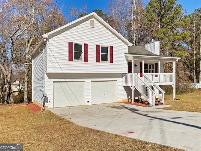 view of front of house featuring a porch, a garage, and a front lawn