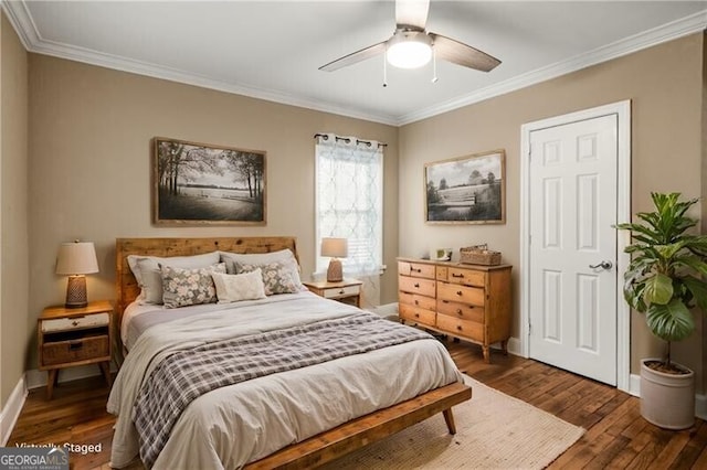 bedroom with ceiling fan, crown molding, and dark wood-type flooring