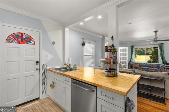 kitchen featuring dishwasher, wood counters, sink, ceiling fan, and light hardwood / wood-style floors