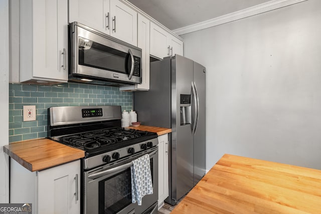 kitchen featuring wooden counters, backsplash, stainless steel appliances, crown molding, and white cabinets