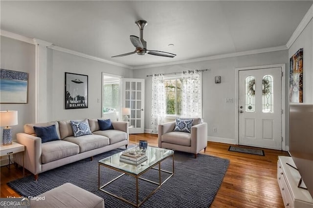 living room with hardwood / wood-style floors, ceiling fan, and crown molding