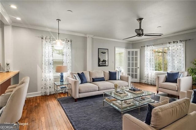 living room with ceiling fan, crown molding, and dark hardwood / wood-style floors