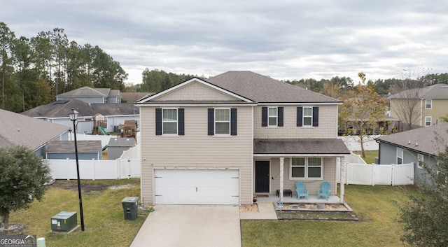 view of front of property featuring a garage and a front lawn