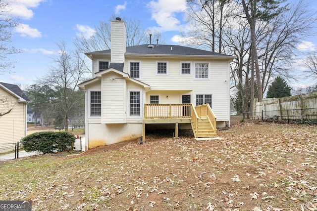 rear view of property featuring a wooden deck