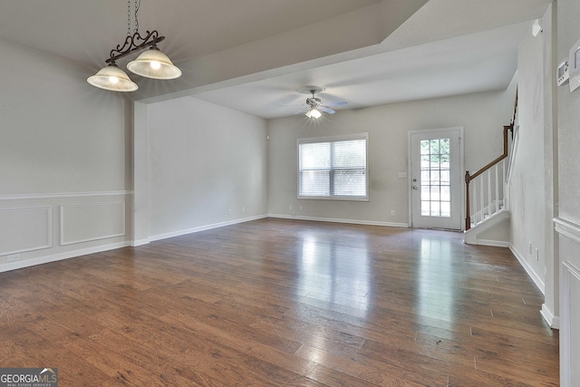 interior space with ceiling fan and dark hardwood / wood-style flooring