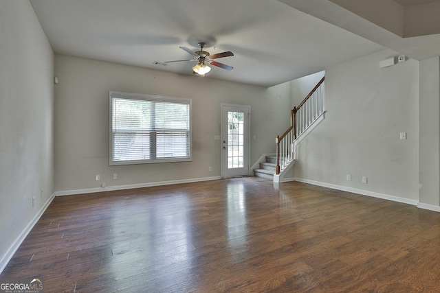 unfurnished living room with dark hardwood / wood-style floors and ceiling fan