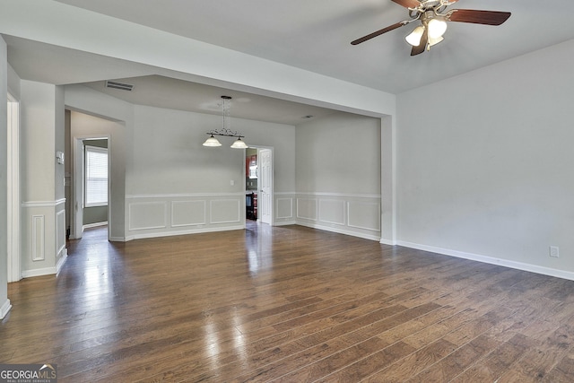 unfurnished room featuring ceiling fan and dark wood-type flooring