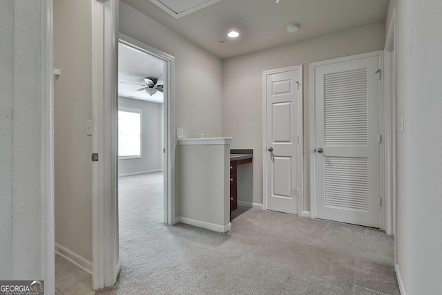 hallway with light colored carpet