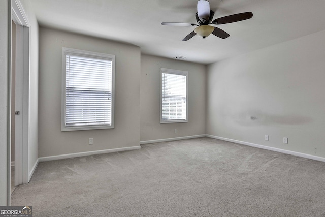 carpeted empty room featuring ceiling fan