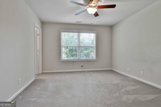 spare room with light carpet and ceiling fan