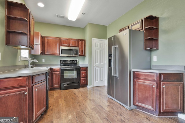 kitchen featuring sink, stainless steel appliances, and light hardwood / wood-style floors