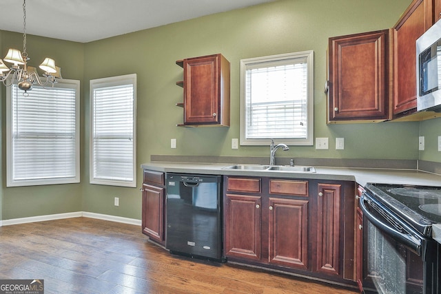 kitchen featuring sink, black appliances, decorative light fixtures, a chandelier, and dark hardwood / wood-style floors