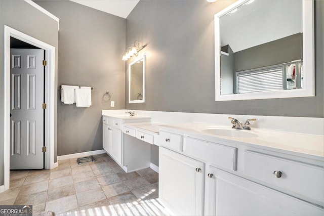 bathroom with vanity, tile patterned flooring, and vaulted ceiling