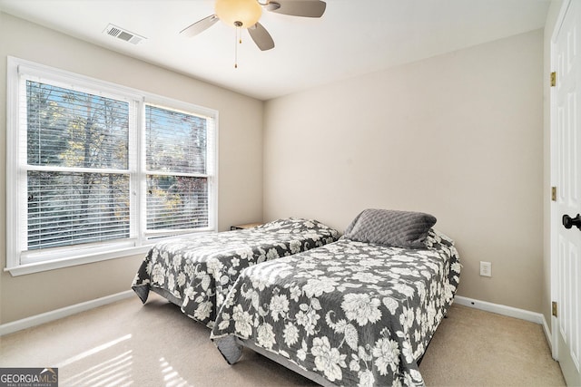 bedroom with light carpet and ceiling fan