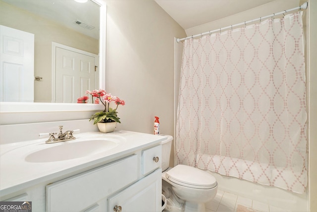 full bathroom featuring vanity, toilet, tile patterned flooring, and shower / bath combo