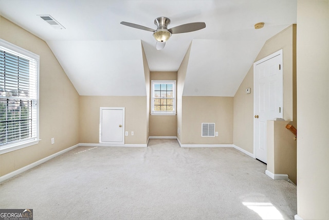 bonus room featuring lofted ceiling, light colored carpet, and ceiling fan