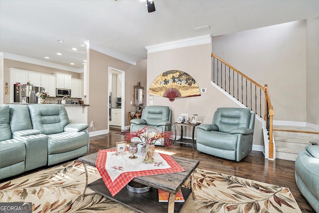 living room with dark hardwood / wood-style flooring and crown molding