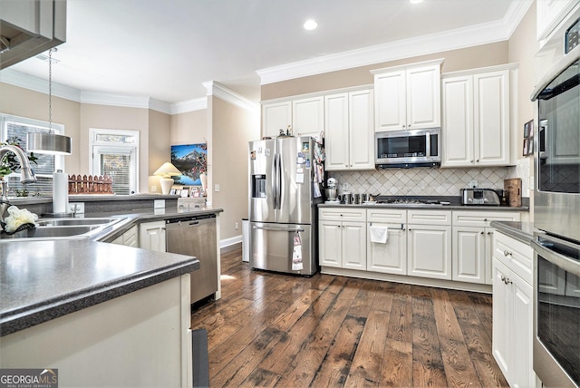 kitchen with ornamental molding, stainless steel appliances, sink, and white cabinets