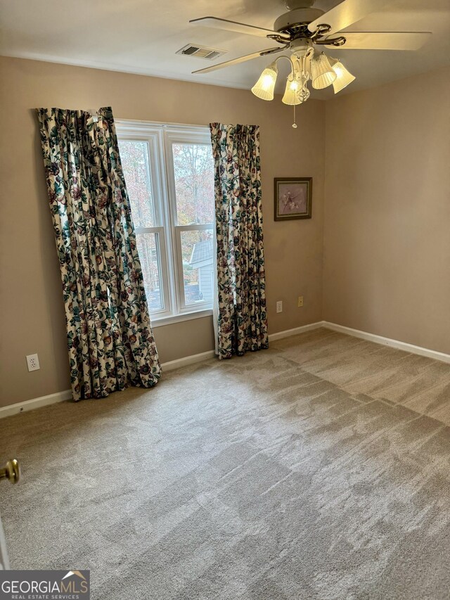 carpeted empty room with ceiling fan