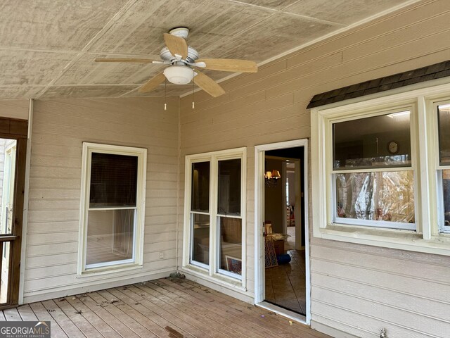 rear view of house featuring a sunroom and a wooden deck