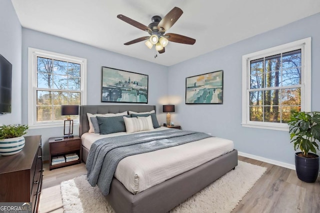 bedroom with light hardwood / wood-style flooring and ceiling fan