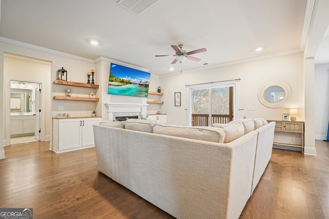 living room with ceiling fan, crown molding, and light wood-type flooring