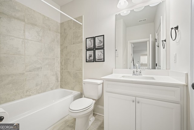 full bathroom featuring toilet, vanity, and tiled shower / bath