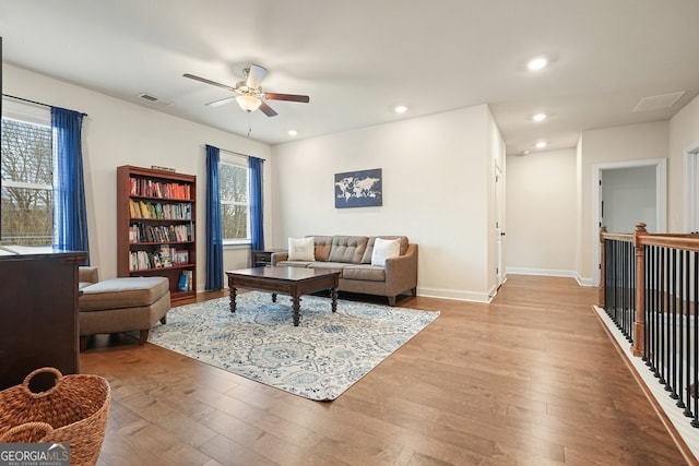 living room featuring ceiling fan and light wood-type flooring