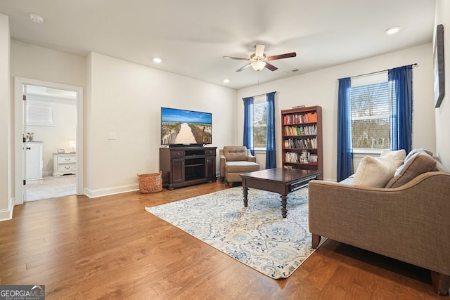 living room with ceiling fan and hardwood / wood-style flooring