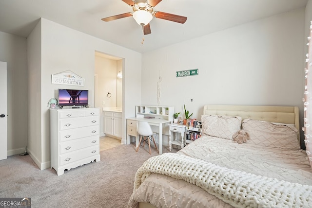 bedroom featuring light carpet, connected bathroom, and ceiling fan