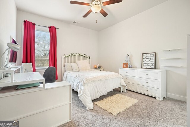 bedroom featuring light colored carpet and ceiling fan