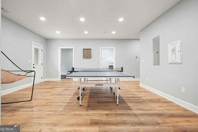 recreation room featuring light hardwood / wood-style floors and electric panel