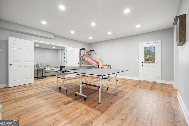 rec room with light hardwood / wood-style floors