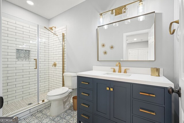 bathroom with toilet, an enclosed shower, vanity, and tile patterned floors