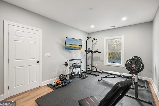 workout room featuring hardwood / wood-style floors