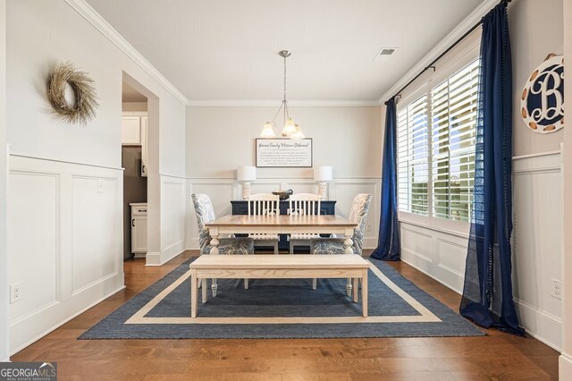 dining room featuring crown molding and dark wood-type flooring